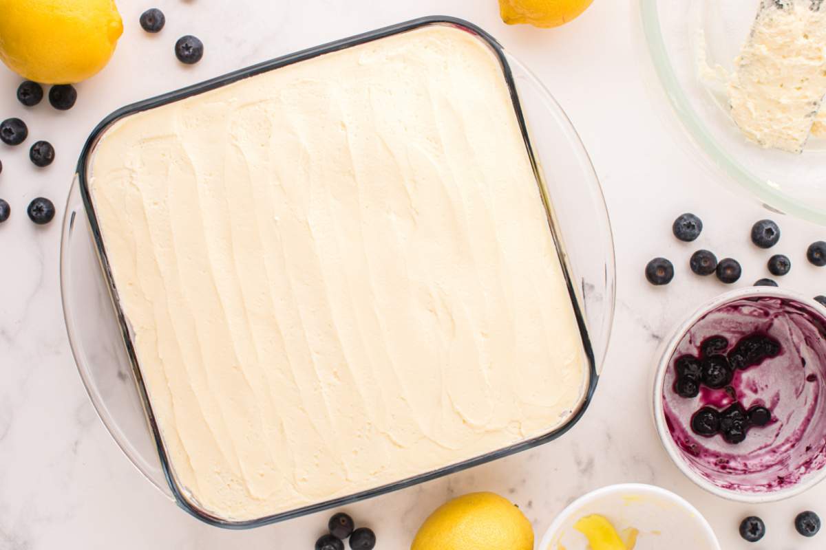 cream mixture spread on top of lady fingers