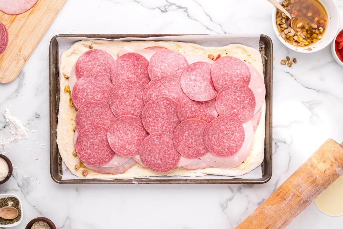 salami slices added to top of meat