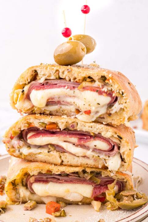 Muffuletta Garbage Bread stacked on a plate