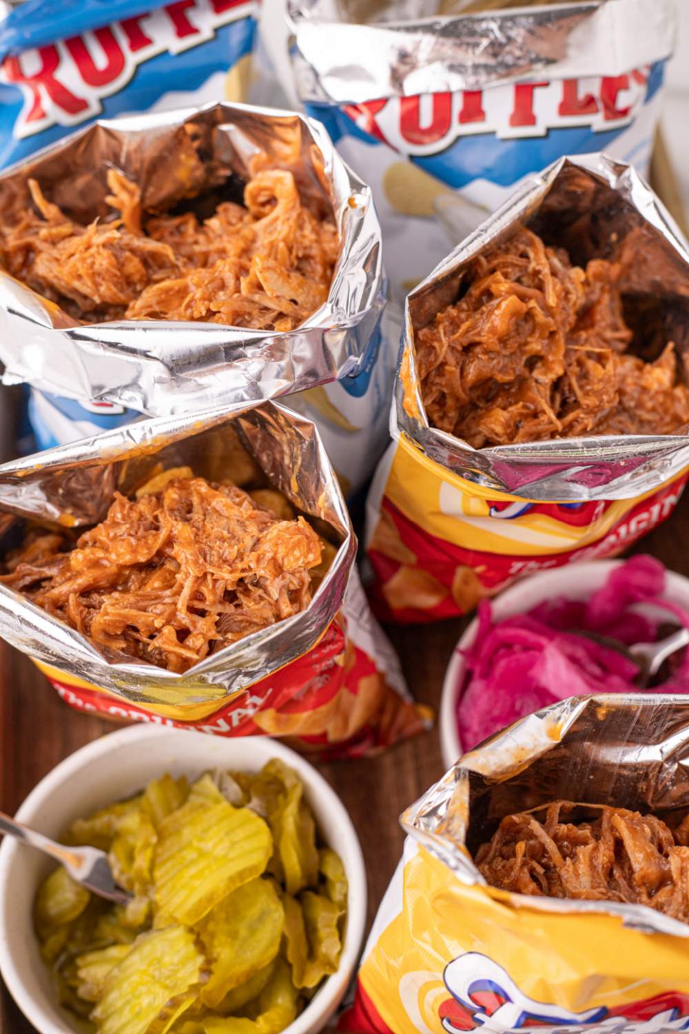 pulled pork being put into potato chip bags