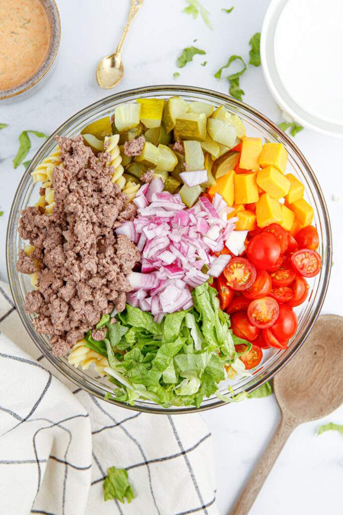 big mac pasta salad ingredients in a bowl