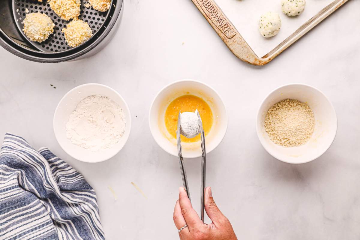 dipping rice balls into eggs