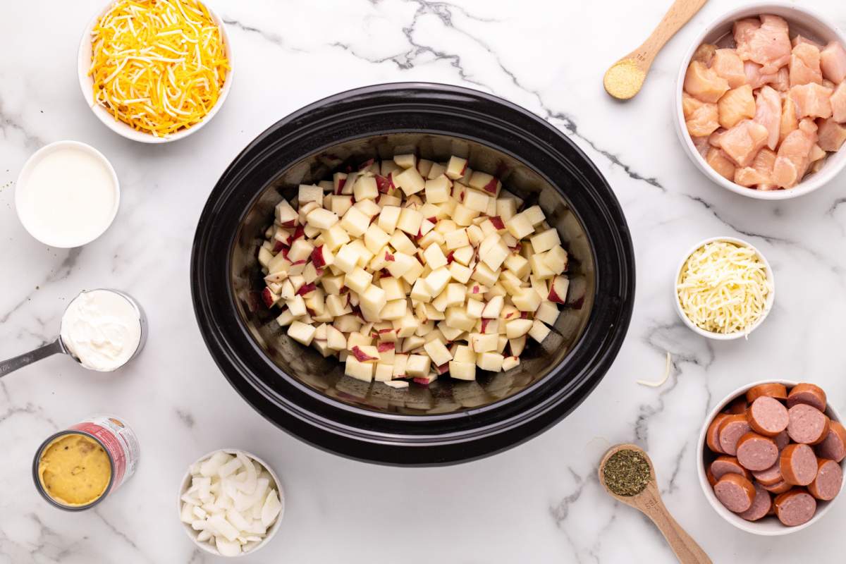 diced potatoes and onions added to slow cooker