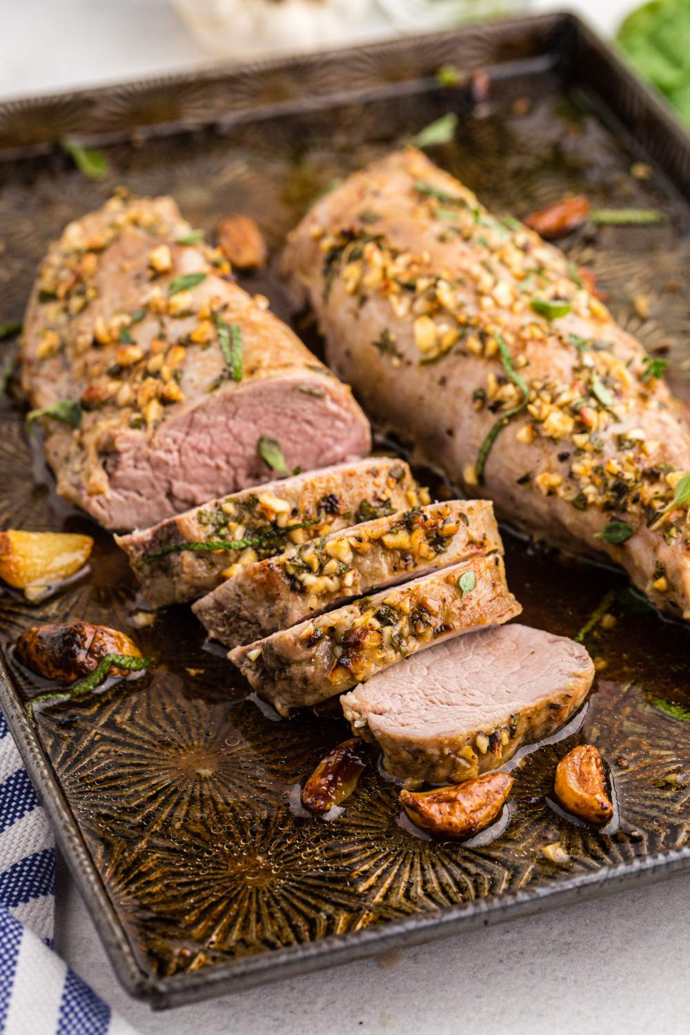 This Garlic Roasted Pork Tenderloin is made to melt in your mouth with buttery goodness and aromatic flavors thanks to the herbs, chopped garlic and basting! via @familyfresh
