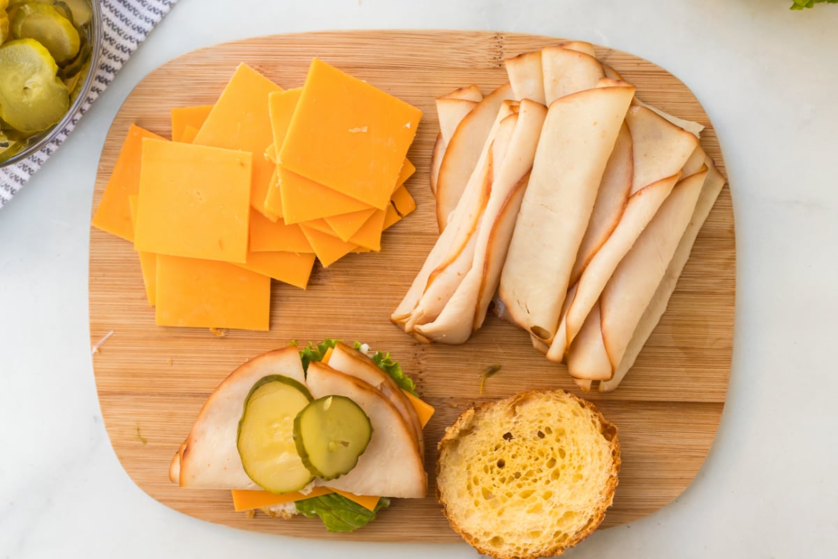 sandwich being made on a cutting board