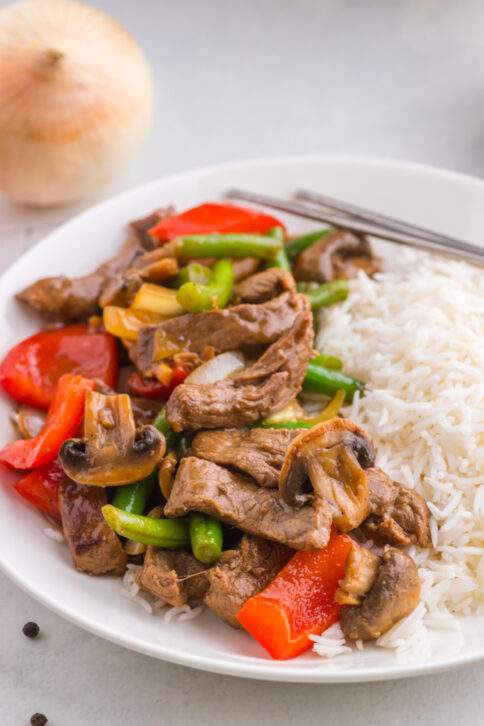 Copycat Panda Express Black Pepper Beef on a plate with rice
