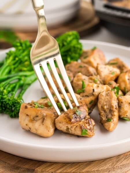 Garlic butter chicken bites on a plate with broccoli