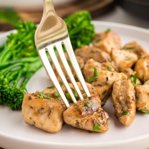 Garlic butter chicken bites on a plate with broccoli