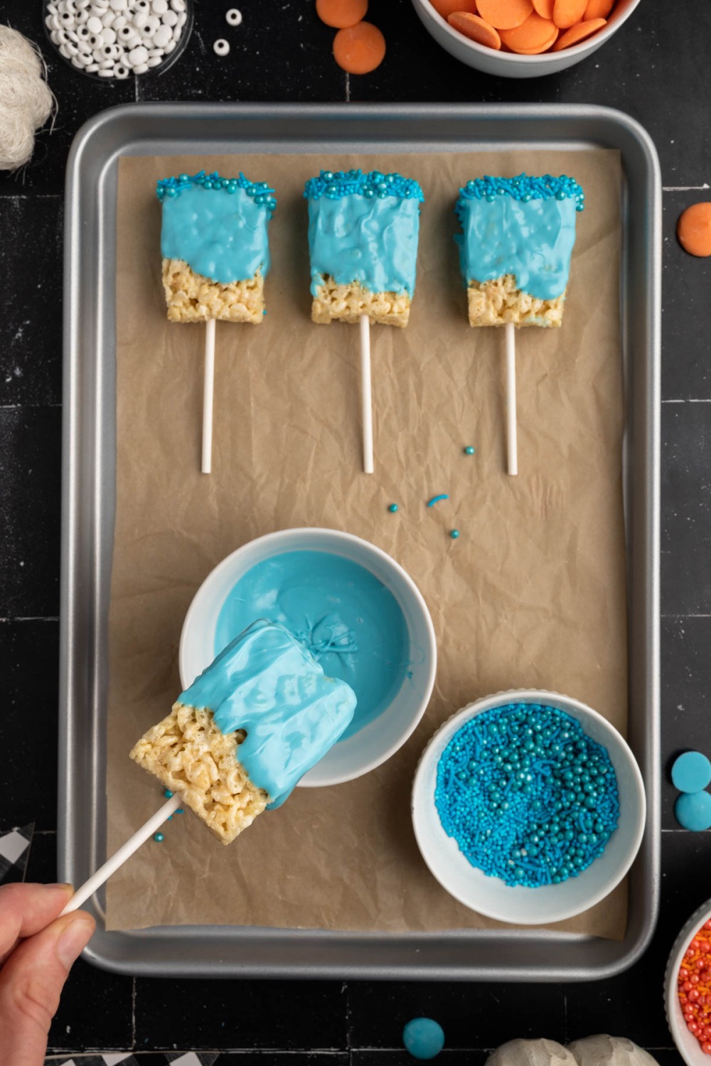 dipping Krispies treat into melted candy melts