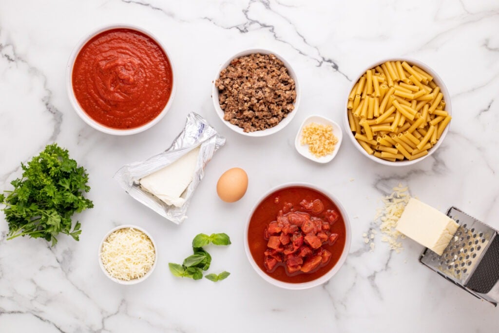 Marinara Sauce, Diced Italian Tomatoes, cooked Italian Sausage, Cream Cheese, egg, Parmesan Cheese, garlic, and basil,
2 teaspoons parsley, chopped
16oz. Ziti Pasta, uncooked
2 cups Mozzarella Cheese, freshly Grated