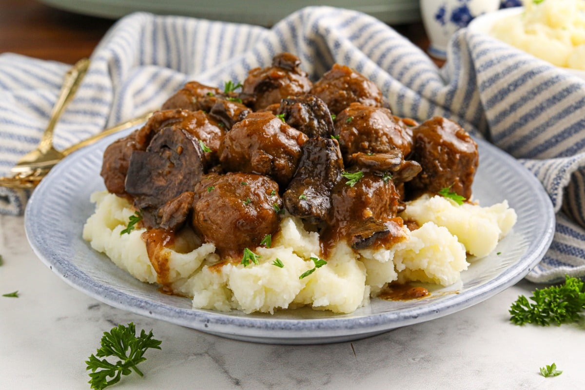 Slow Cooker Salisbury Meatballs on a plate with mashed potatoes