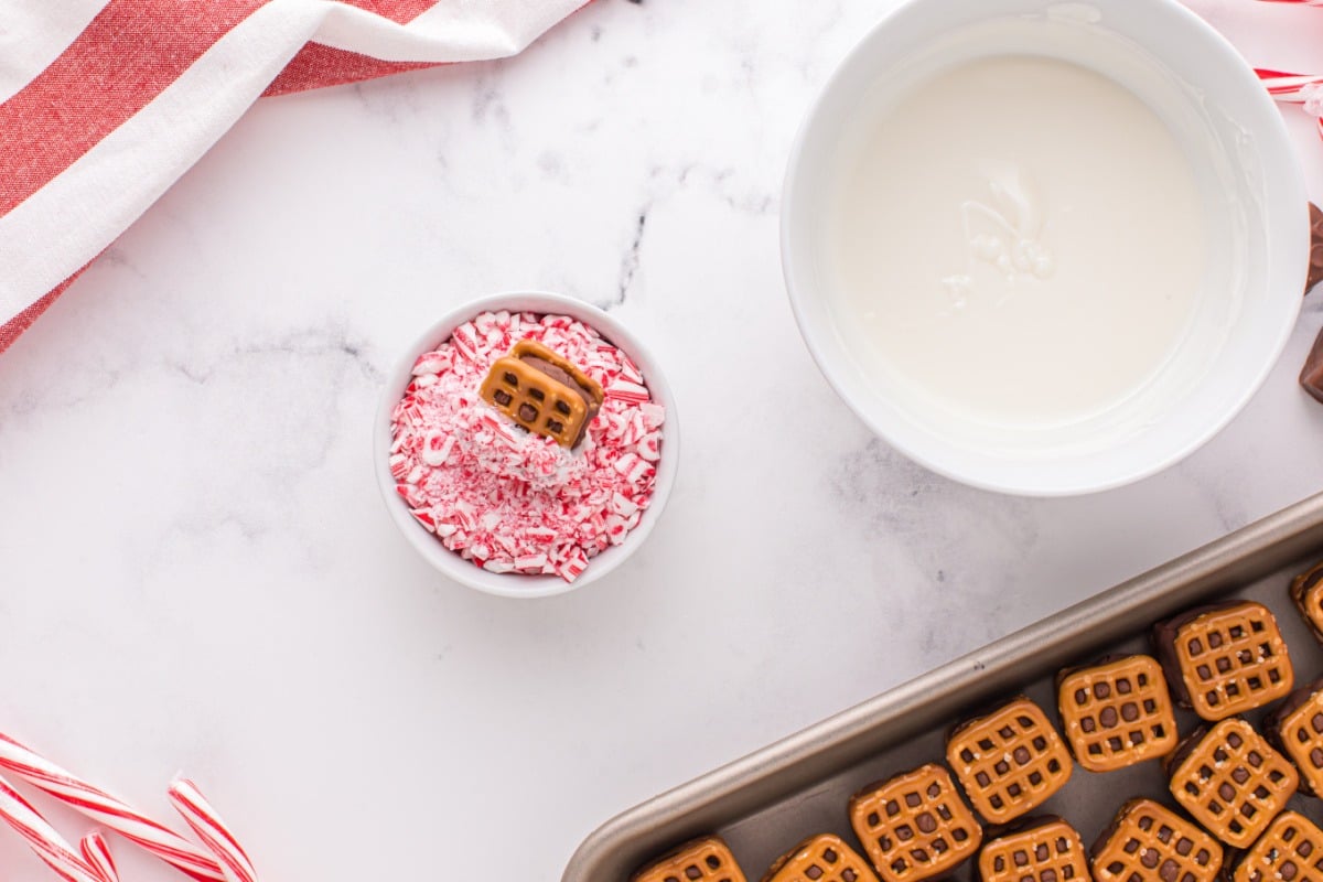 dipping pretzels into peppermint bits