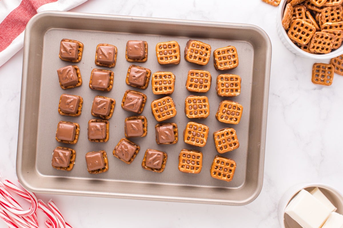 placing mini stickers on top of pretzels