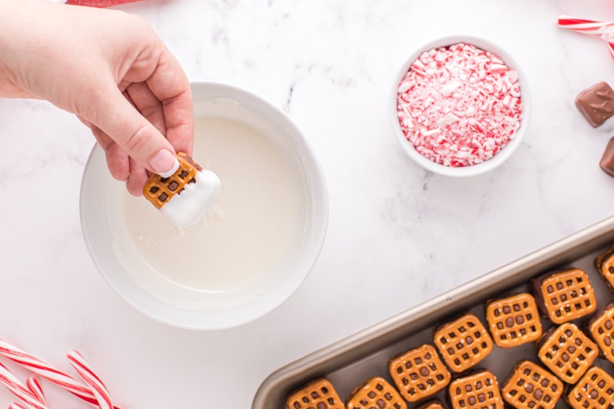 dipping pretzel into chocolate