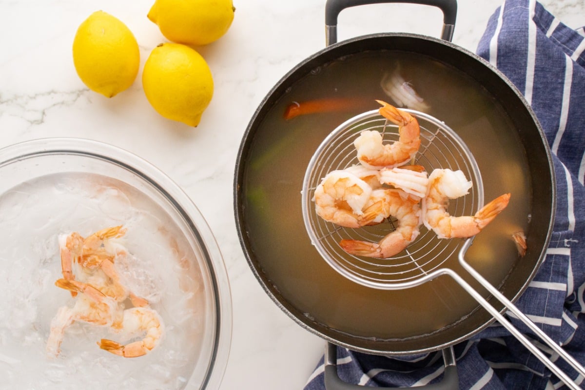scooping shrimp out of pot