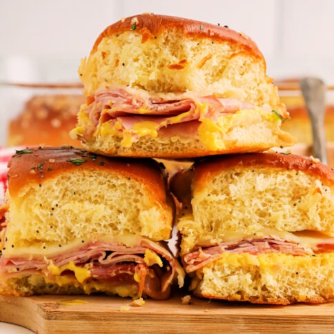 Honey Mustard Ham and Cheese Sliders stacked on a platter