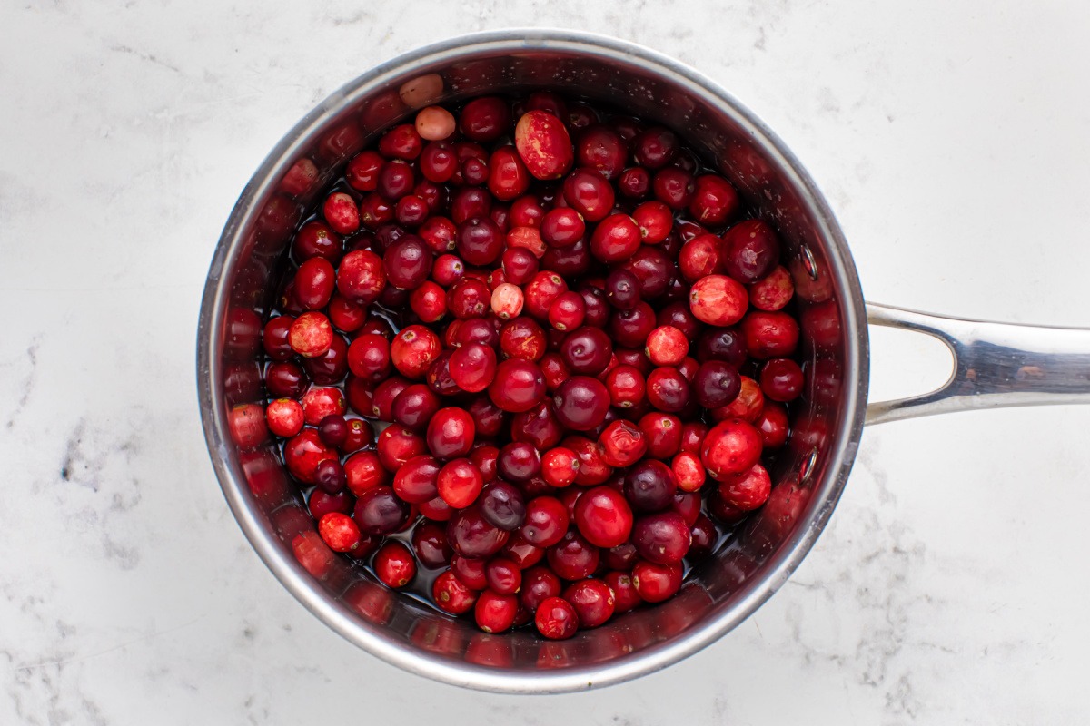 cranberries in a pot with water and sugar