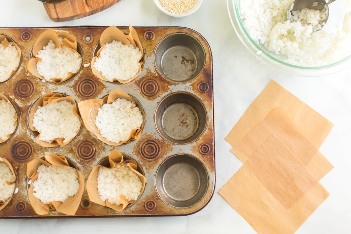 rice being placed into muffin tins