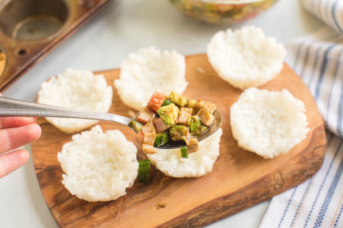 filling rice cups with crab mixture