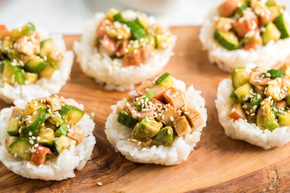 In a separate trencher combine the crab meat, avocado and cucumber. Pour the sauce over it , toss and let it nippy in the refrigerator till the rice is ready.