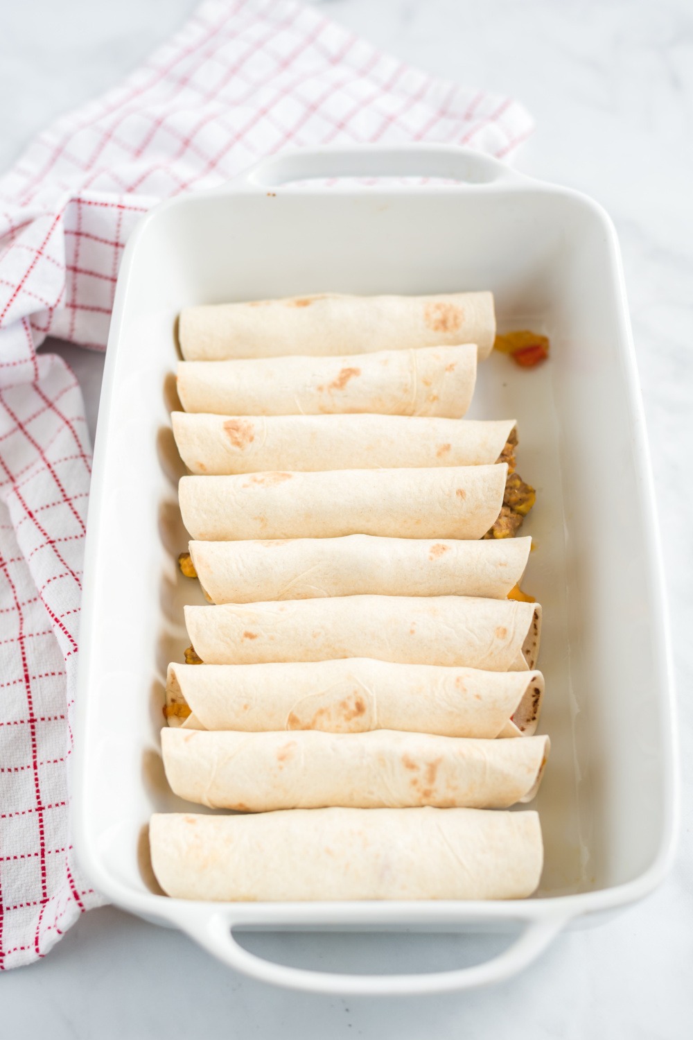 taquitos in a baking dish