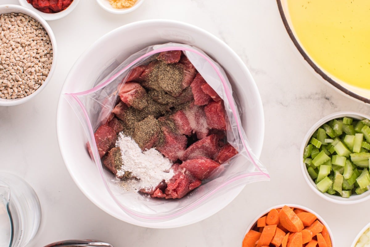 flour and seasoning added to bag with meat