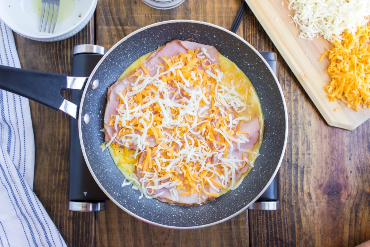 shredded cheese and ham added in to pan