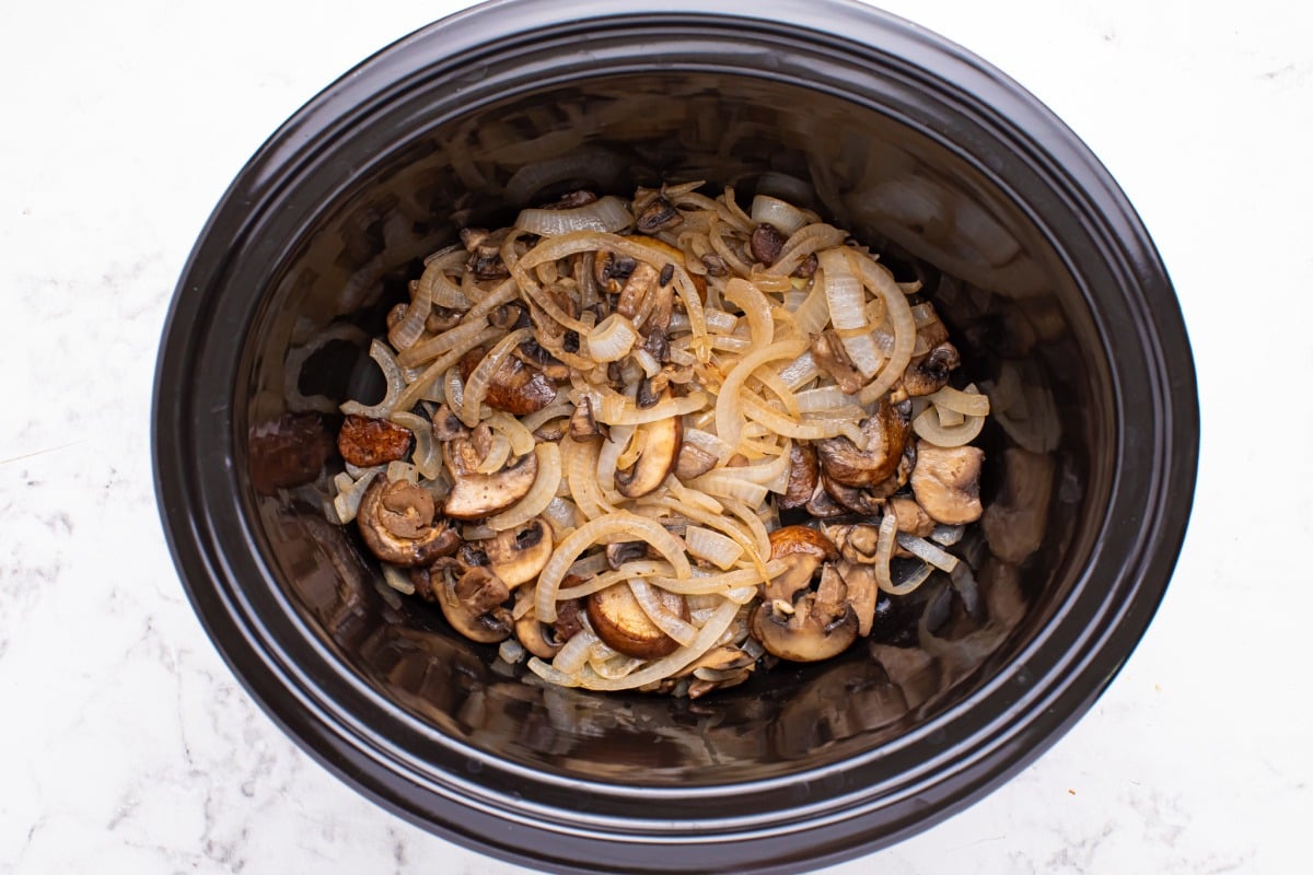onions and mushrooms added to slow cooker
