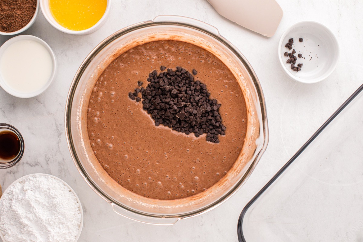 mini chocolate chips added to bowl with cake batter