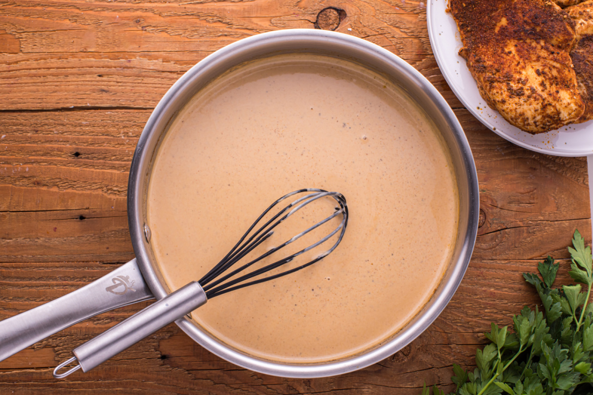 whisking in heavy cream to pan