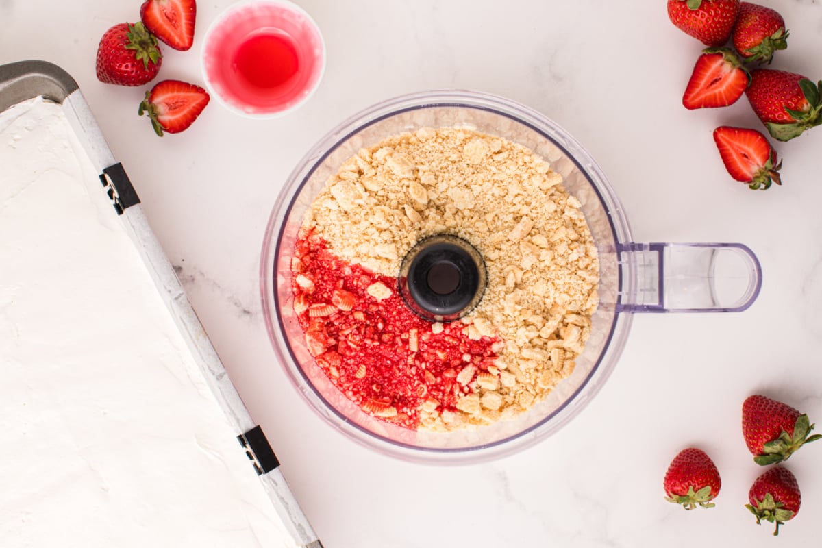 strawberry syrup placed in food processor with cookie crumbs