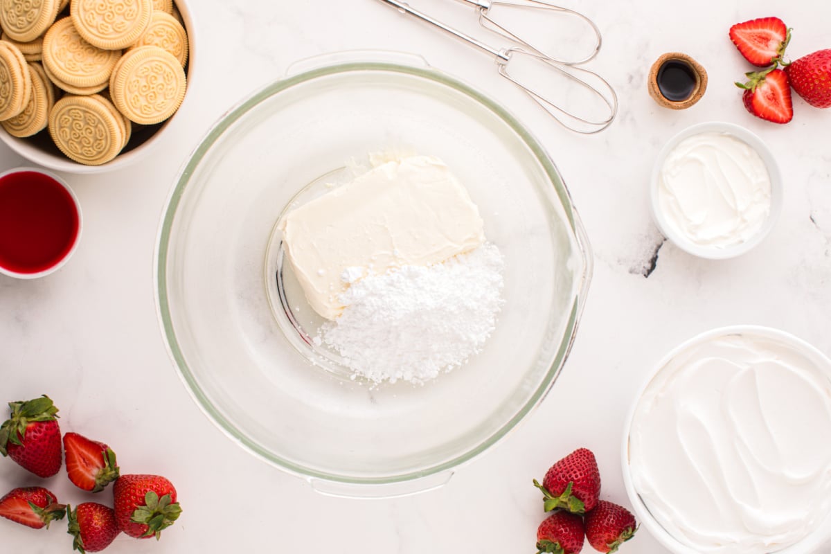 ream cheese and powdered sugar in a mixing bowl