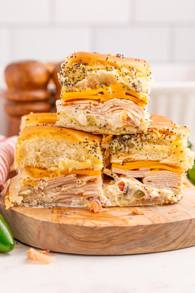Jalapeno Popper Chicken Sliders stacked on a platter