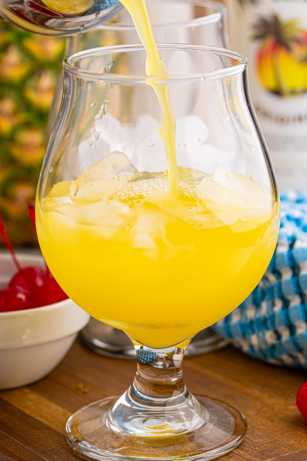 pouring juice and rum into glass