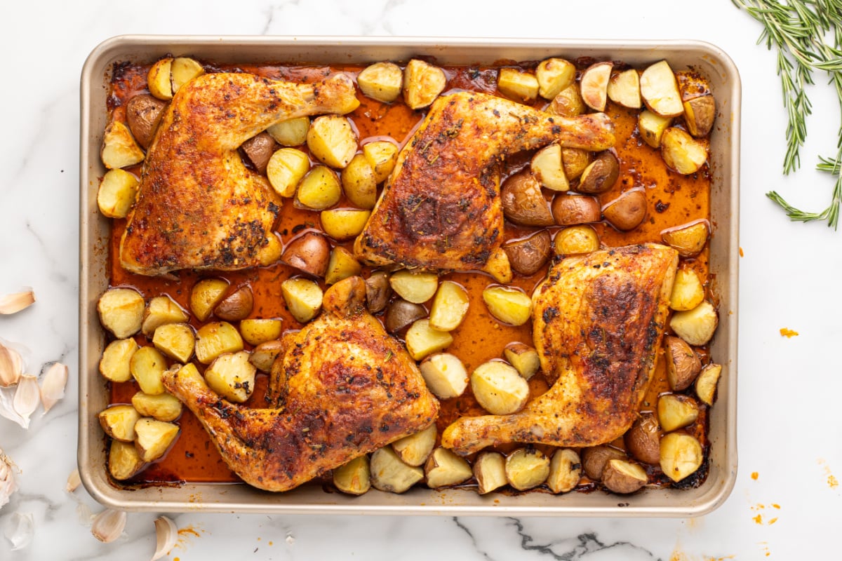 cooked potatoes and chicken on baking sheet