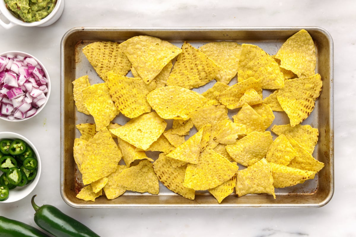nacho chips on a baking sheet