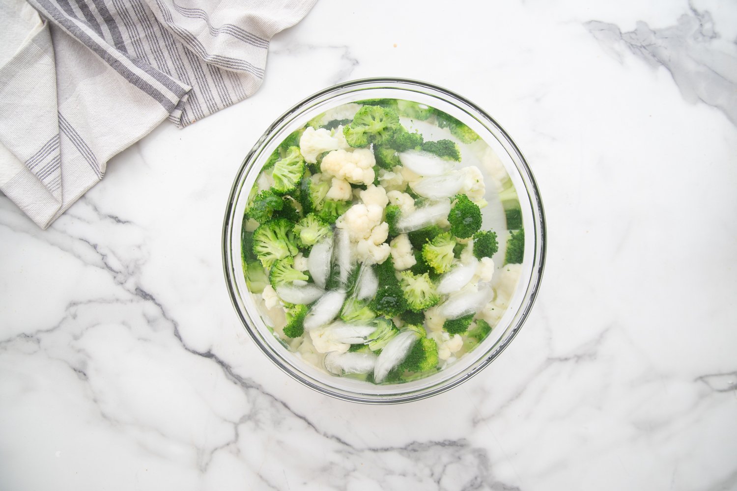 broccoli and cauliflower in bowl with ice water