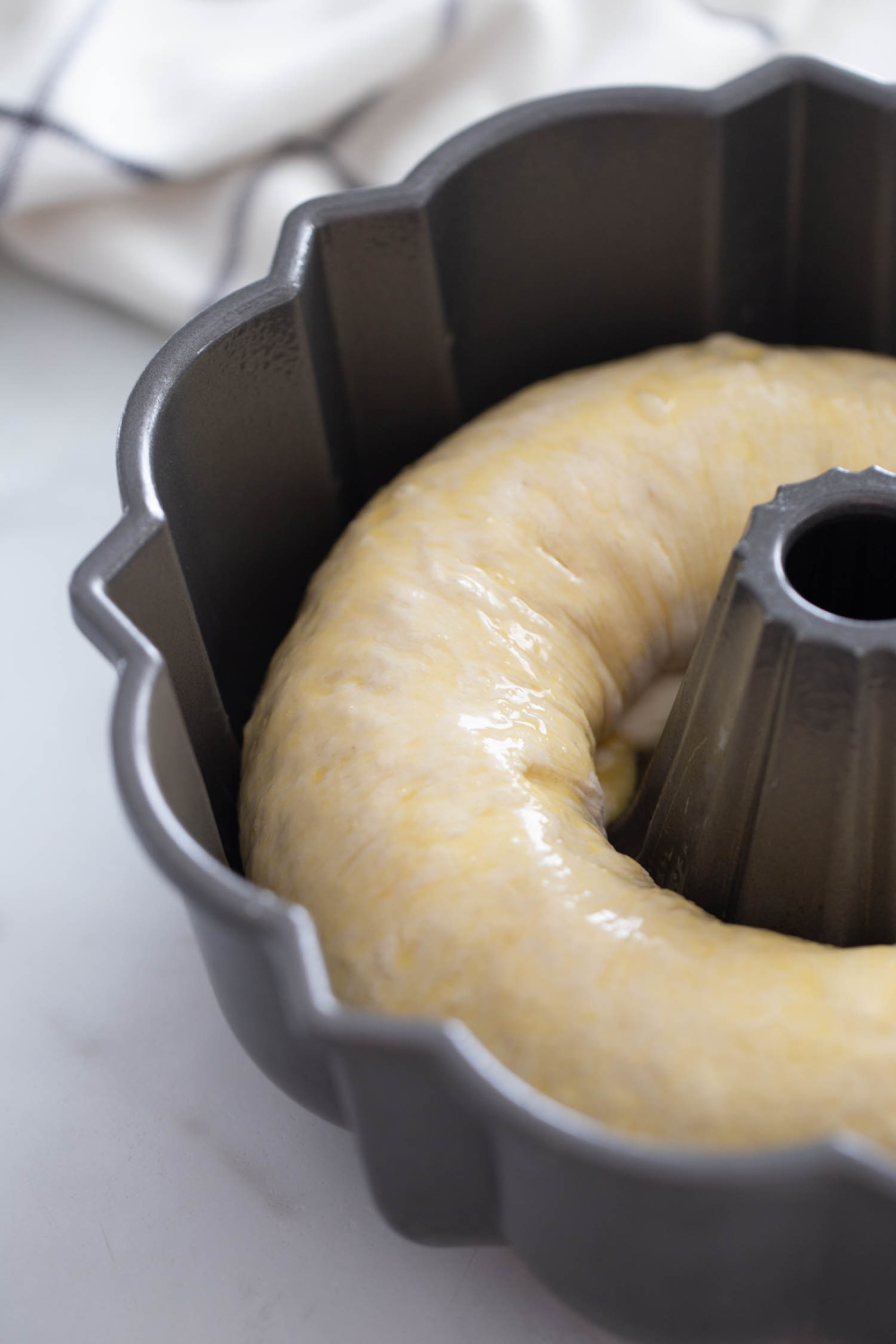 egg brushed on dough in bundt pan