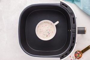 mug with cake batter in an air fryer