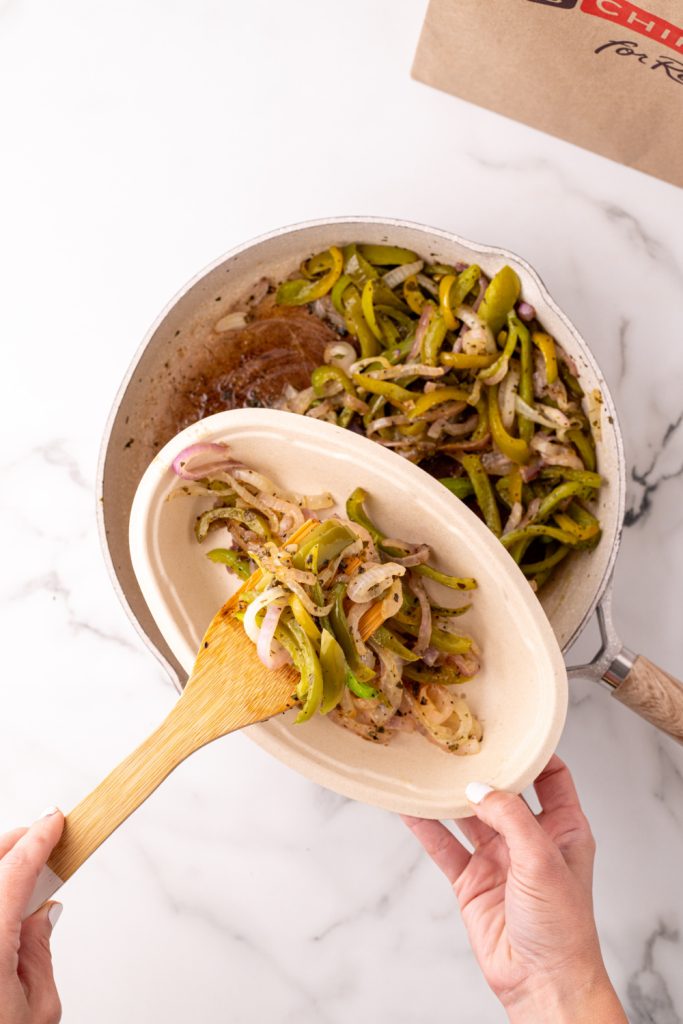 Copycat Chipotle Fajita Veggies being spooned into container