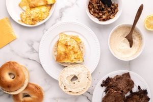 egg placed on sauced bagel