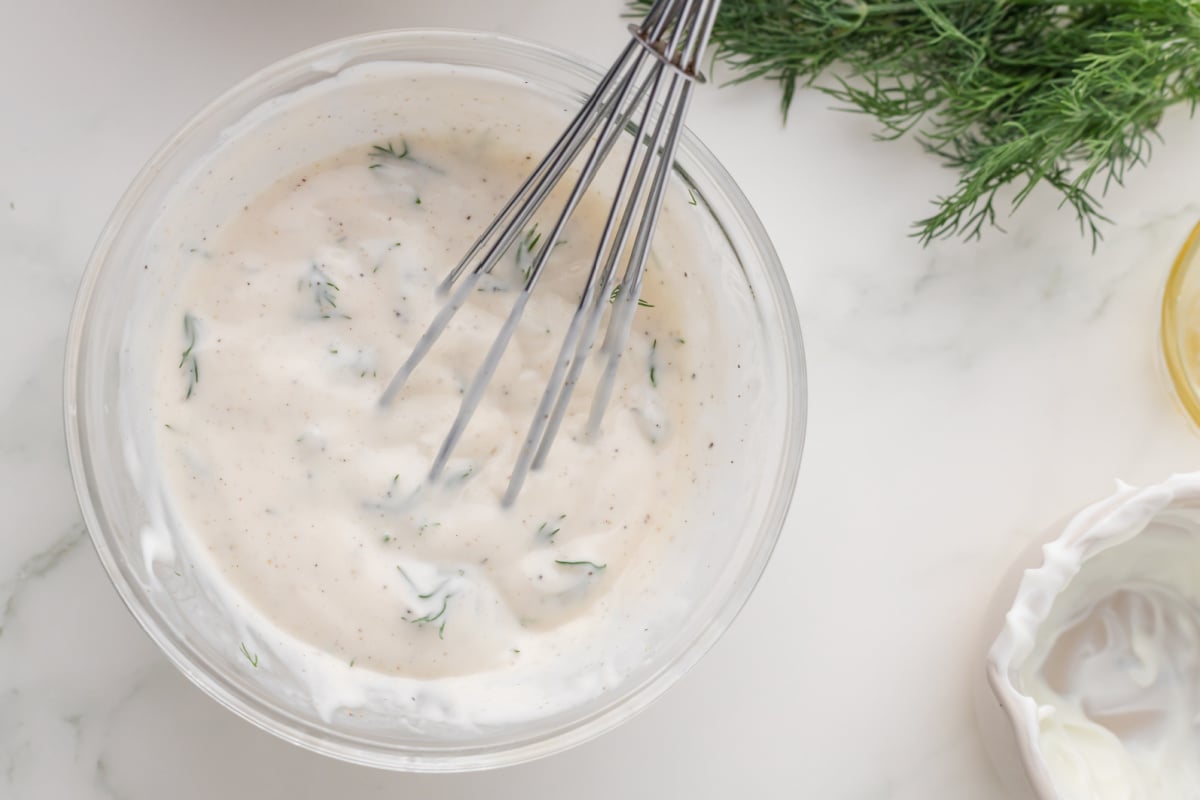 dressing being mixed in a bowl