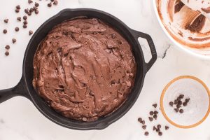 brownie batter placed in cast iron skillet