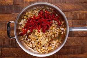 garlic and sun dried tomatoes added to pan
