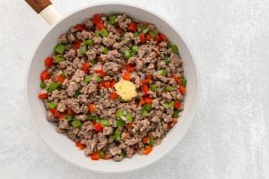adding garlic to pan