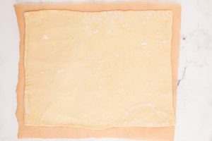 dough rolled out on parchment paper