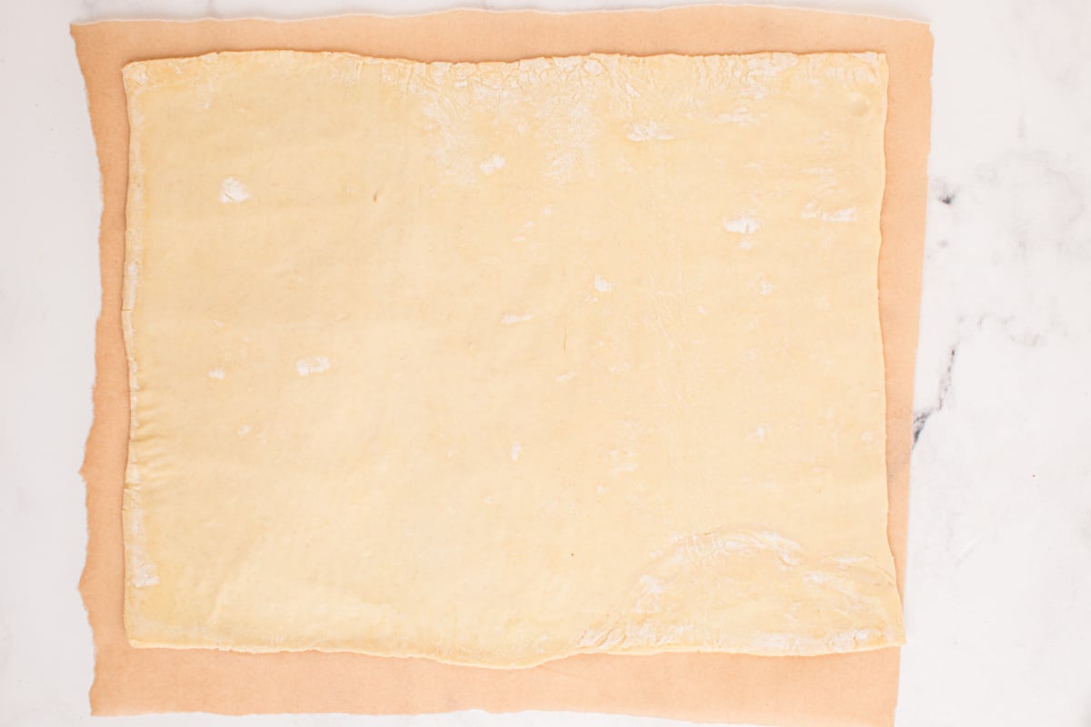 dough rolled out on parchment paper