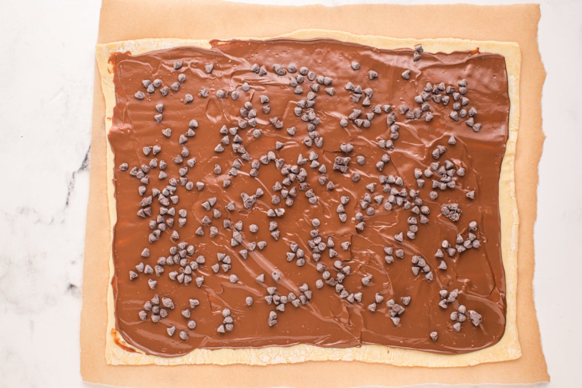 nutella and chocolate chips spread on top of pastry