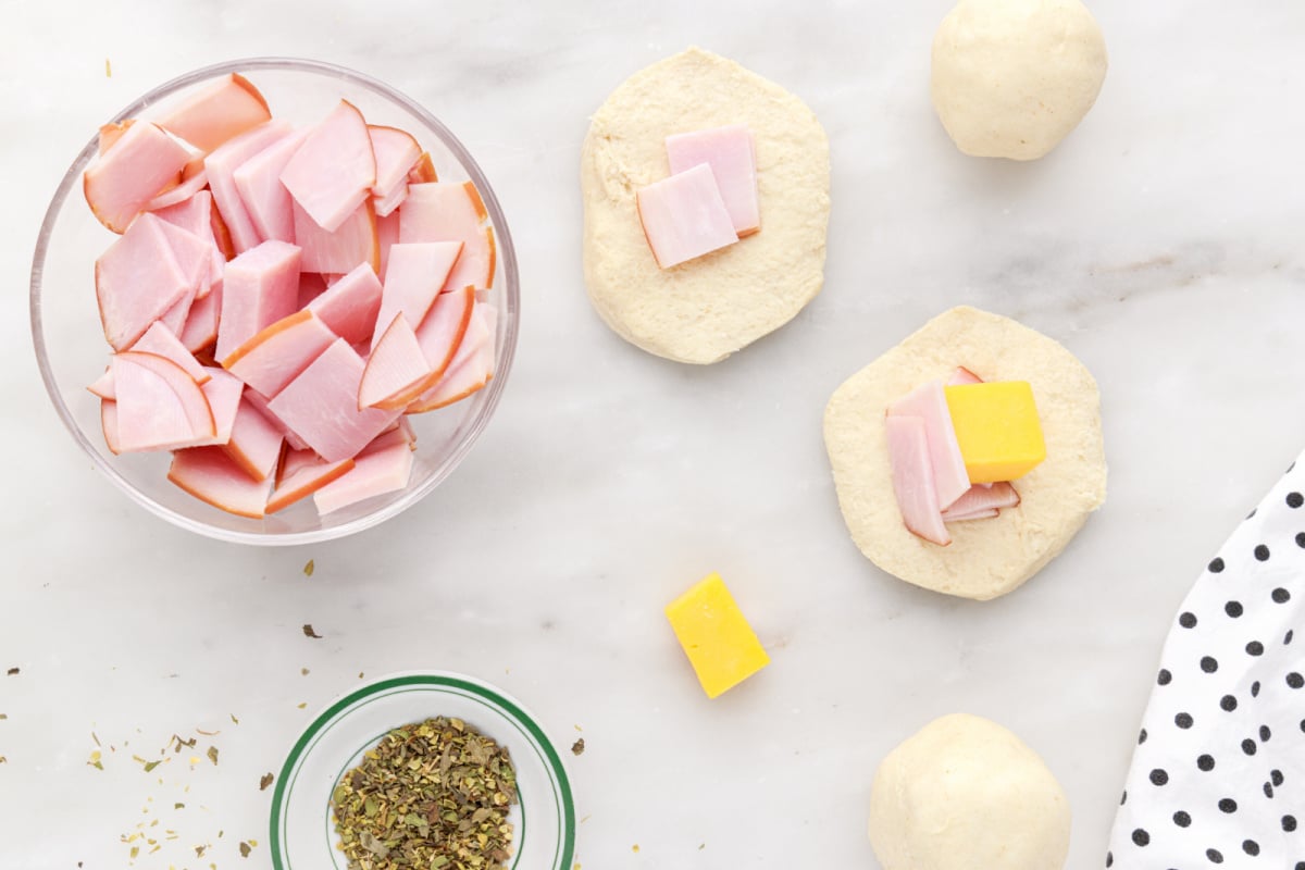 ham and and cheese placed in center of biscuit half