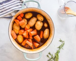 carrots and potatoes added to the pot